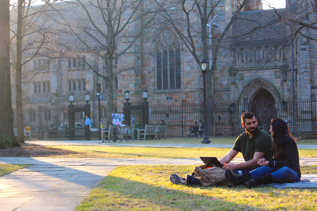 ivy league students sitting on Yale campus
