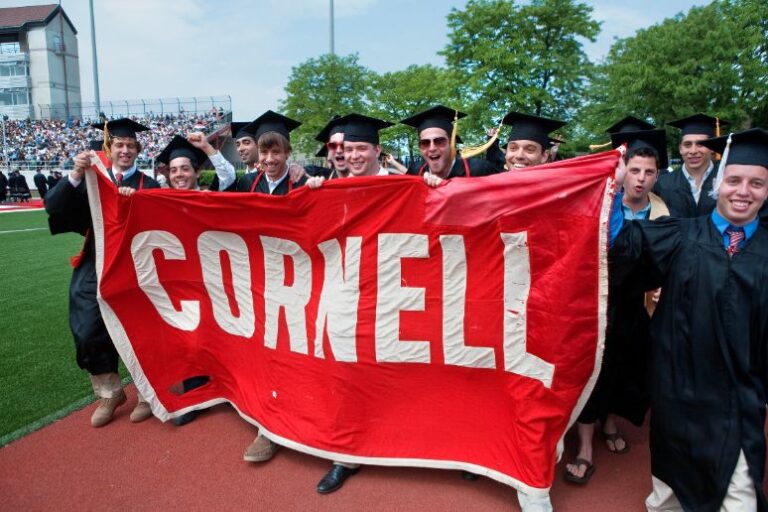 students carrying Cornell banner